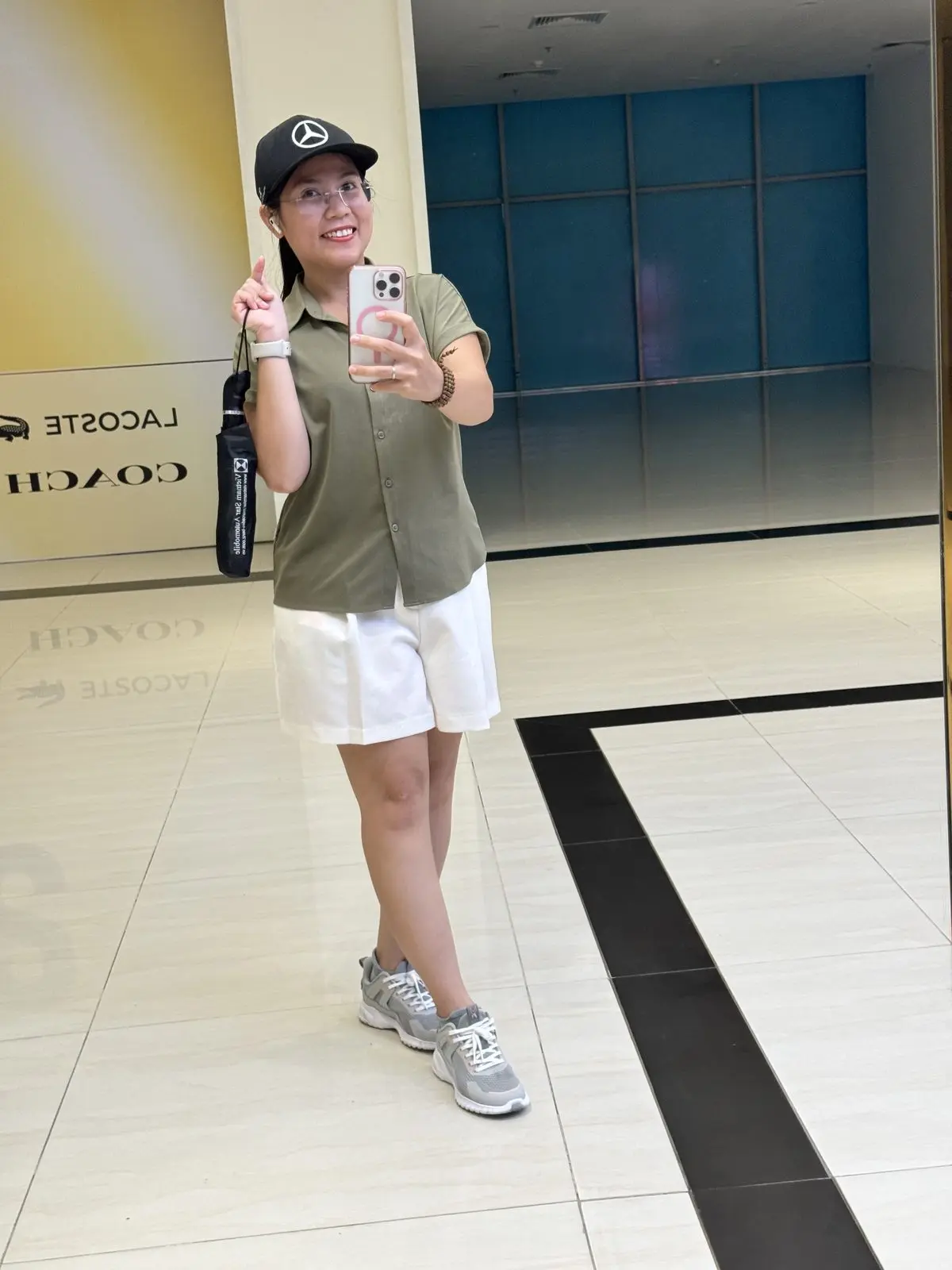 Loo đội mũ lưỡi trai chụp ảnh qua gương